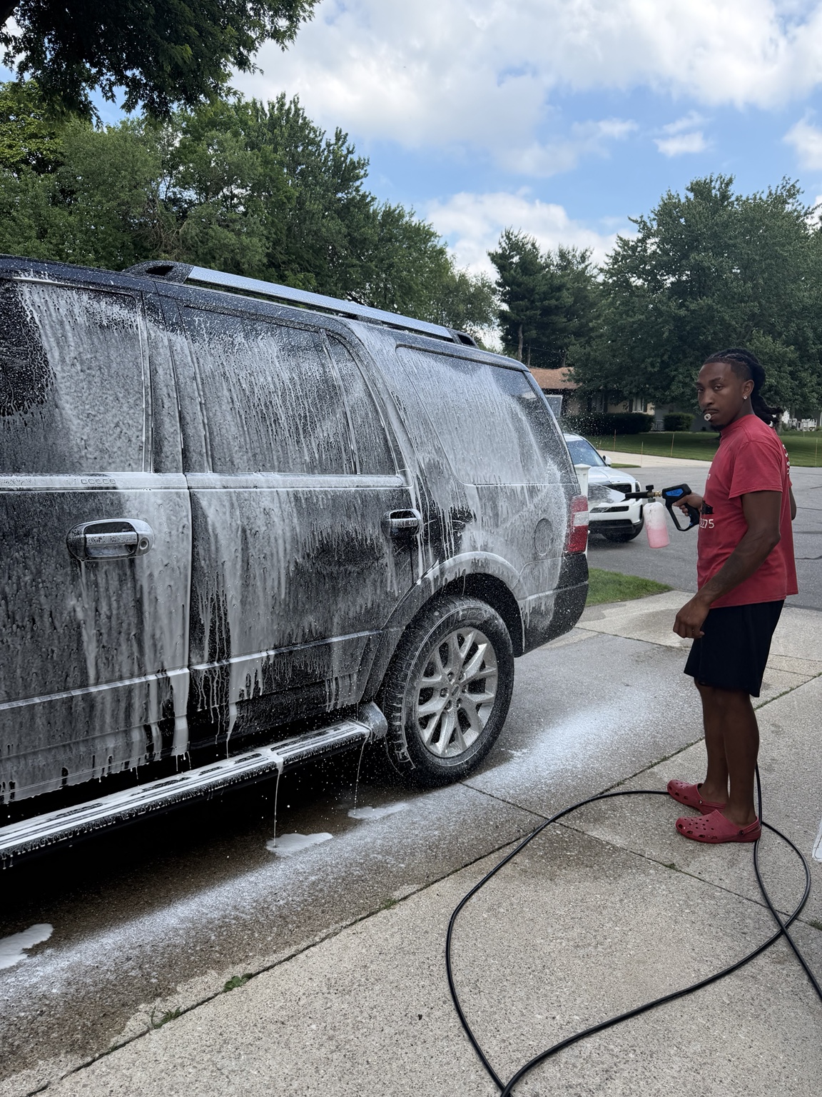 Black SUV covered in wash foam